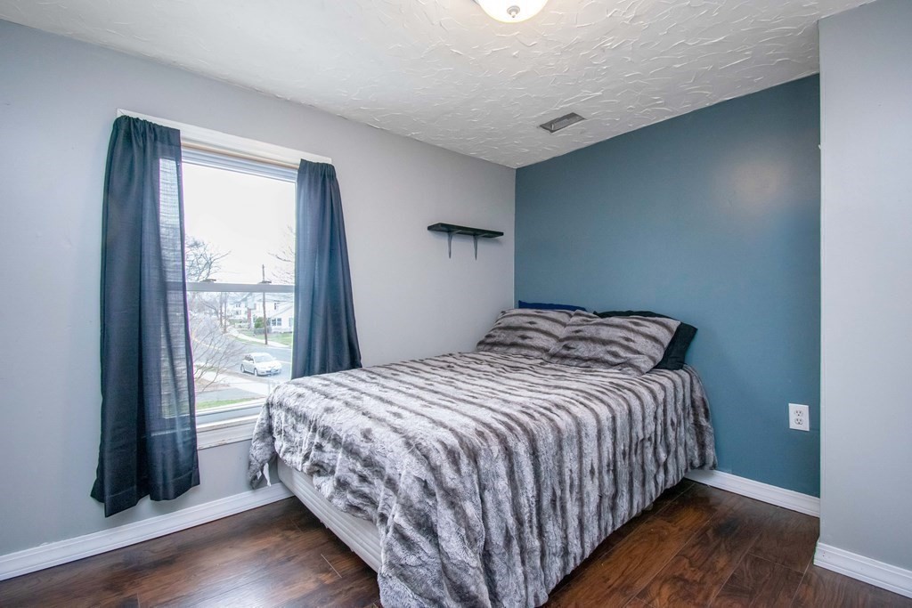 220 Nottingham Street Springfield, MA 01104 - Photo 23 of 30 a bedroom with a bed and a large window