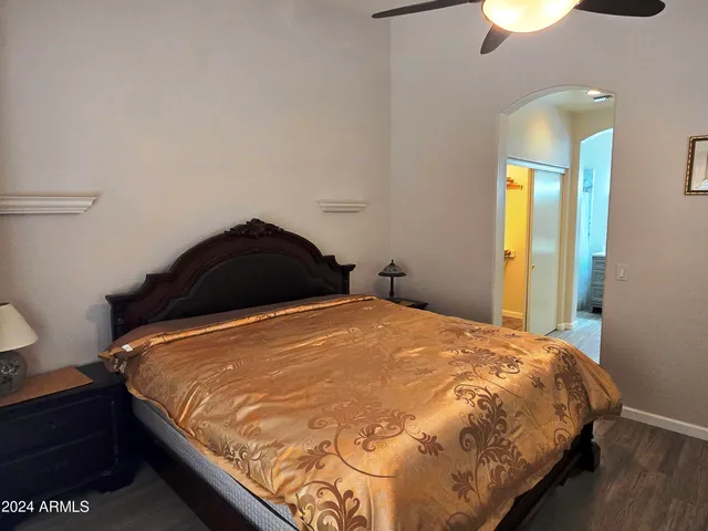 a bedroom with a bed and a lamp