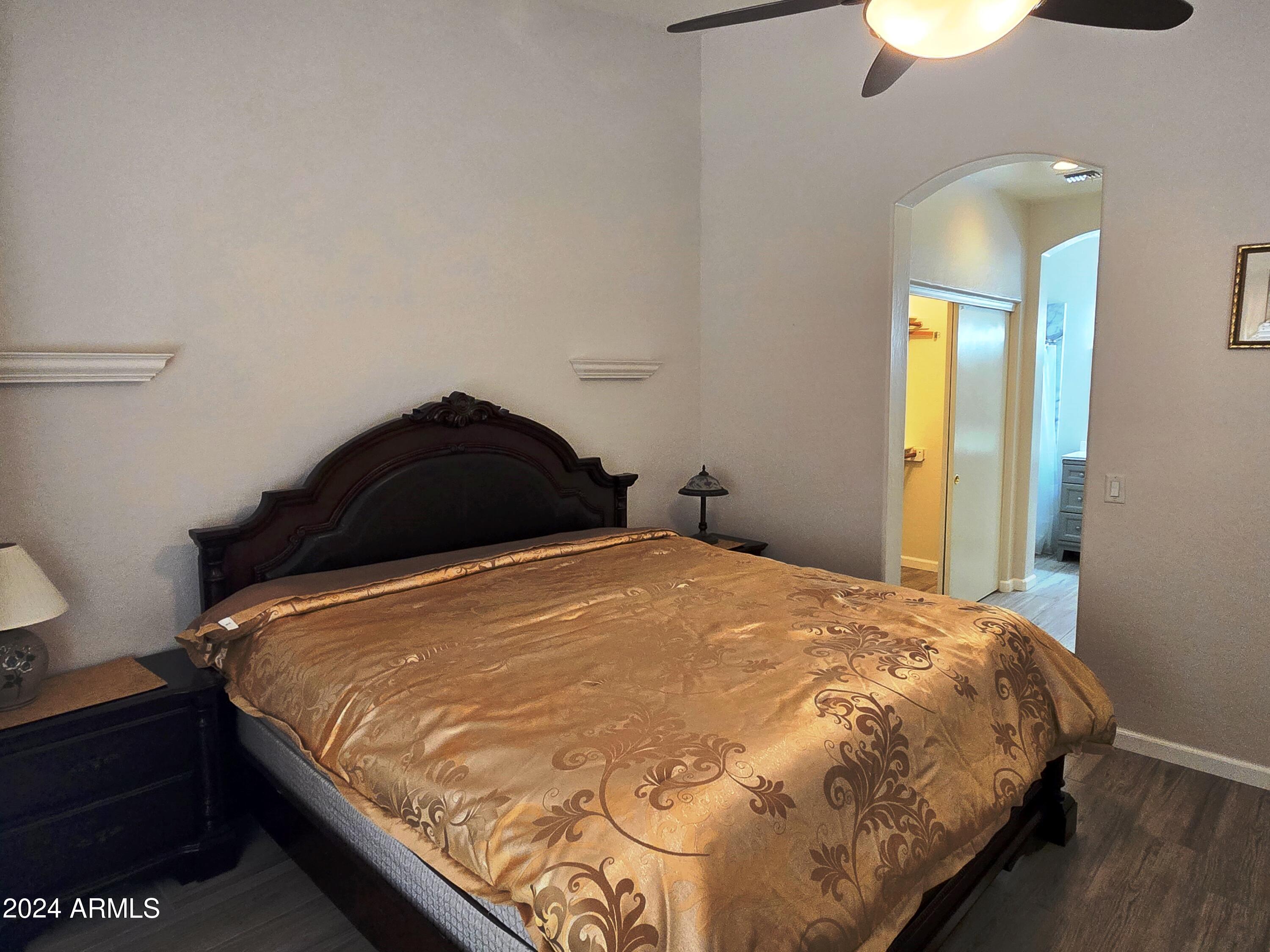 2101 South Meridian Road, Unit 34 Apache Junction, AZ 85120 - Photo 11 of 59 a bedroom with a bed and a lamp