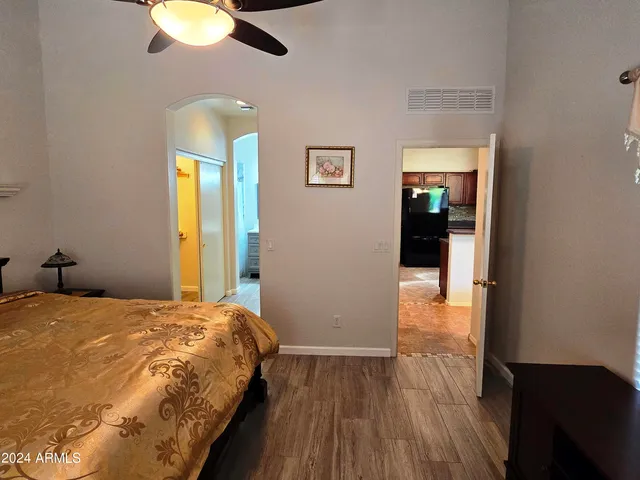 a bedroom with a bed and painting on the wall