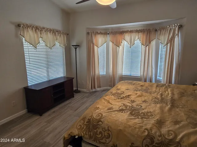 a bed sitting in a bedroom next to a window