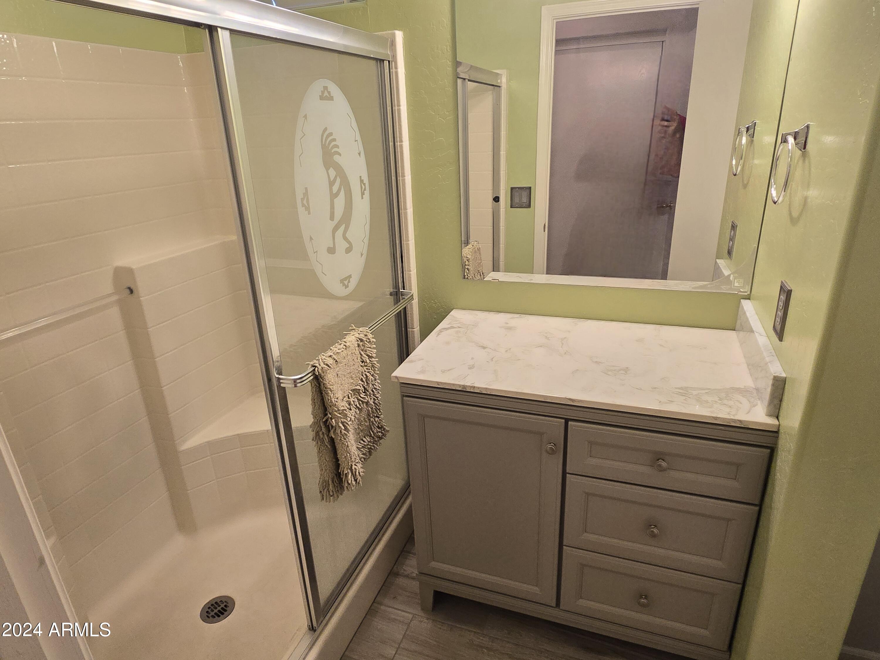 2101 South Meridian Road, Unit 34 Apache Junction, AZ 85120 - Photo 20 of 59 a bathroom with a granite countertop sink a mirror a washer and dryer