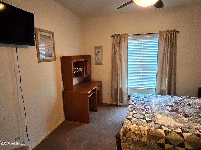 a bedroom with a bed and flat screen tv