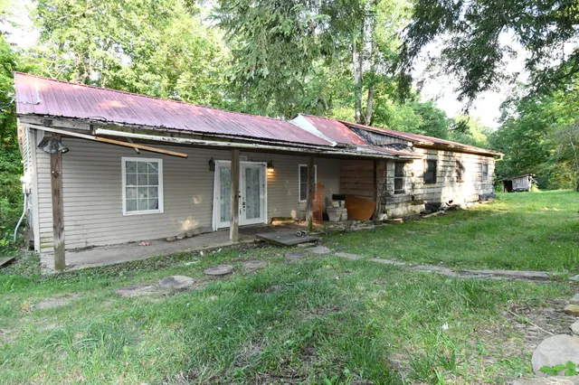 a backyard of a house with table and chairs