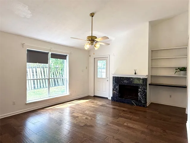 a view of livingroom with furniture wooden floor window and fireplace