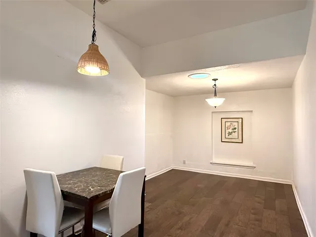 a view of a dining room with a table and chairs