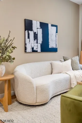 a living room with a couch and a potted plant