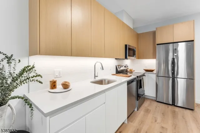 a kitchen with a refrigerator and a sink