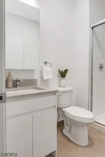 a bathroom with a sink toilet and a mirror