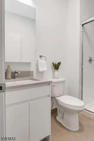 a bathroom with a sink toilet and a mirror