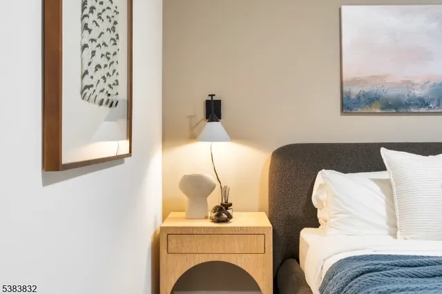 a bedroom with a bed and a painting on the wall