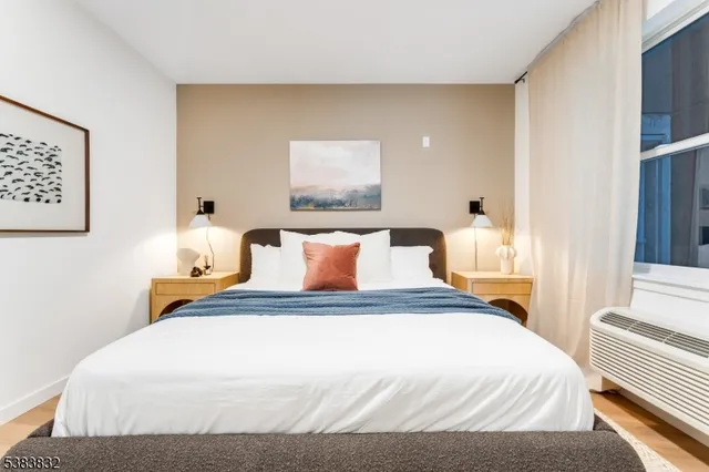 a bedroom with bed and window