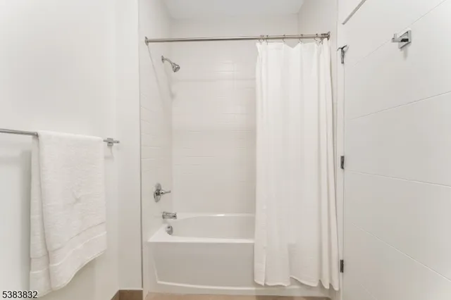 a bathroom with a shower and a bath tub