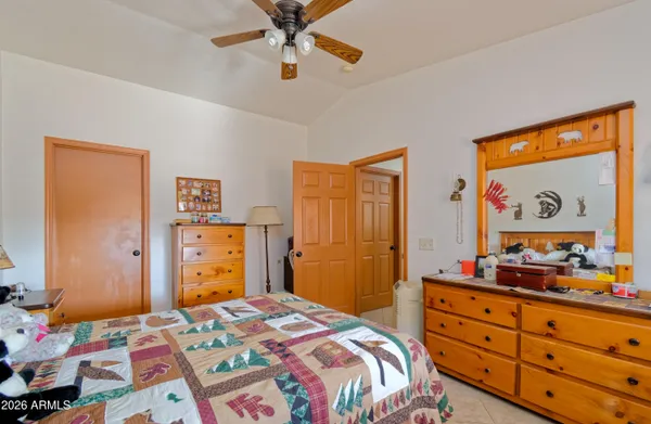 a bedroom with a bed and a dresser in it