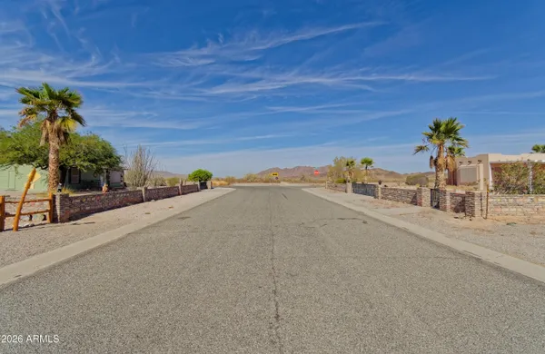 a front view of a building with large trees
