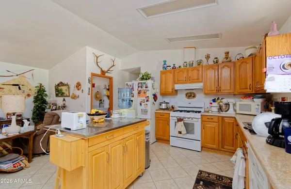 a kitchen with stainless steel appliances granite countertop a stove top oven a sink dishwasher and cabinets with wooden floor
