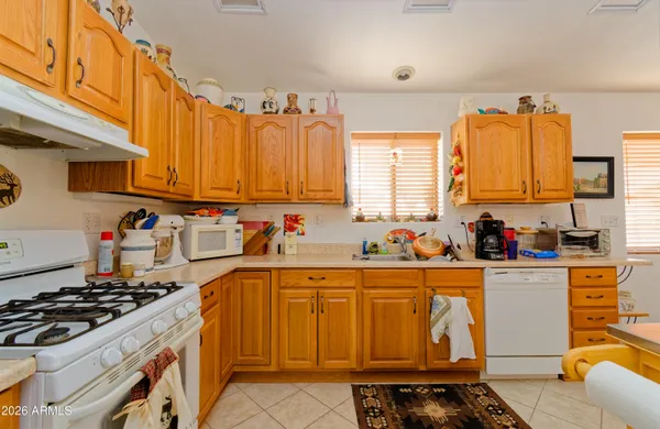 a kitchen with stainless steel appliances a stove a sink and a refrigerator
