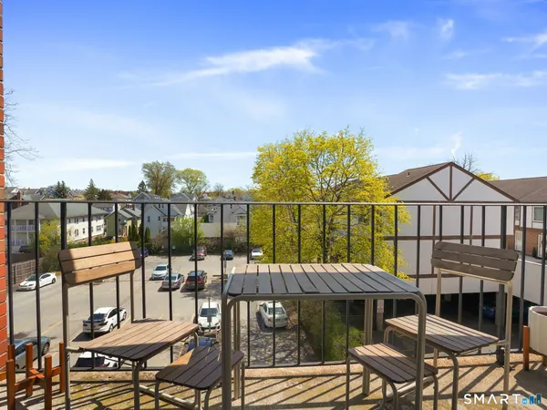a view of a chairs and table in patio with a lake view