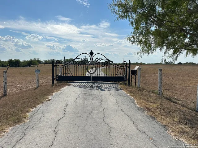 a view of a road with wooden fence