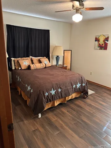 a bed sitting in a bedroom and wooden floor