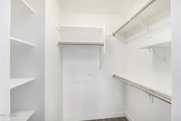 a view of walk in closet with empty racks