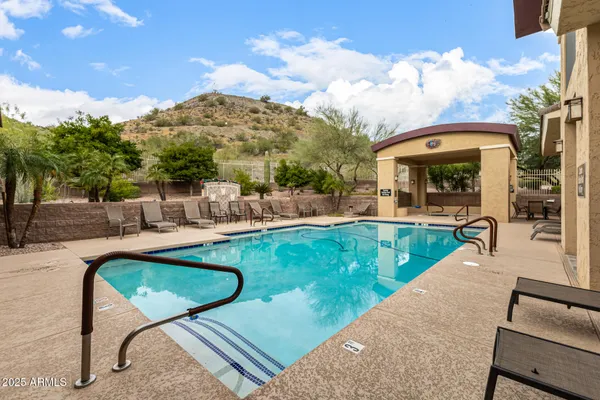 a swimming pool with outdoor seating and yard