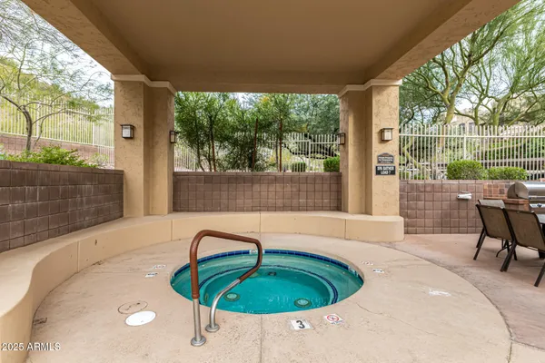 a view of a patio with a table and chairs
