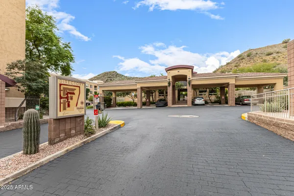 a view of a white house with a swimming pool table and chairs