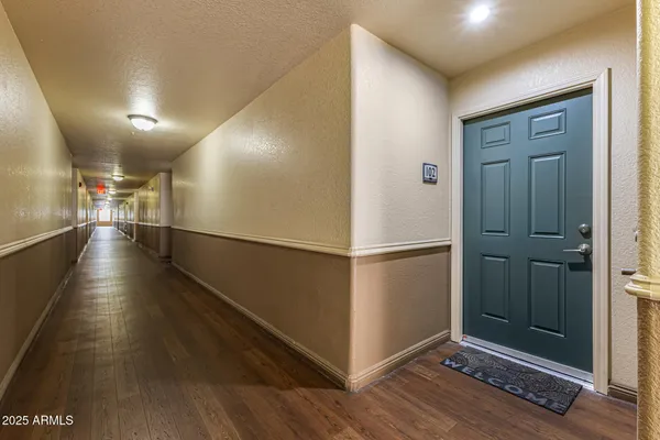 a view of a hallway with wooden floor