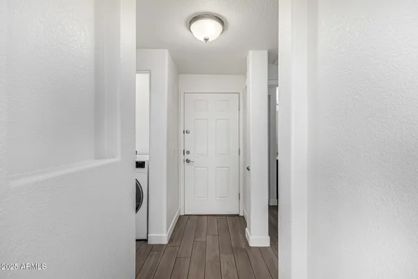 a view of a hallway with wooden floor