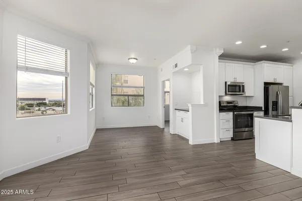 a view of kitchen with refrigerator microwave and stove top oven