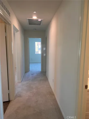 an empty room with closet and windows
