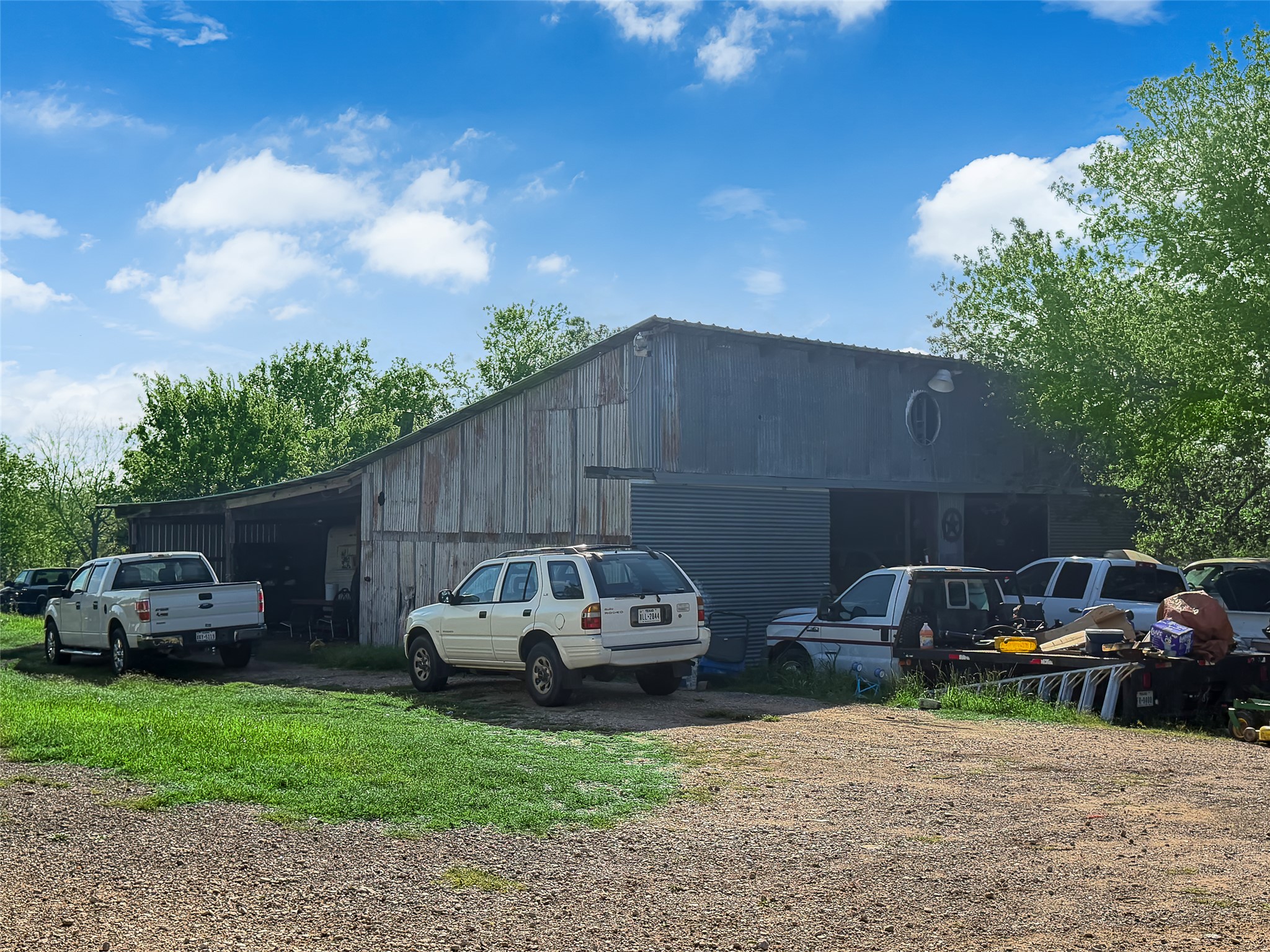 925 Long Hollow Road Dale, TX 78616 - Photo 24 of 26 Rustic barn structure featuring corrugated metal siding and a wood plank facade