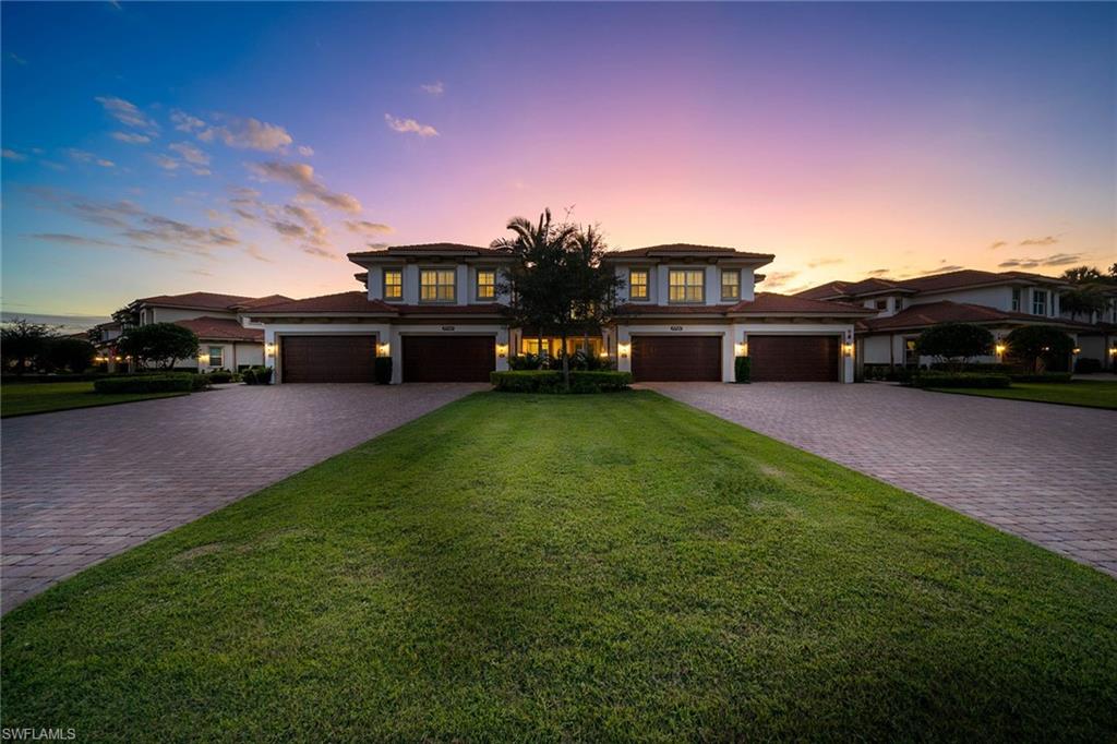a view of a yard with cars parked in front of it