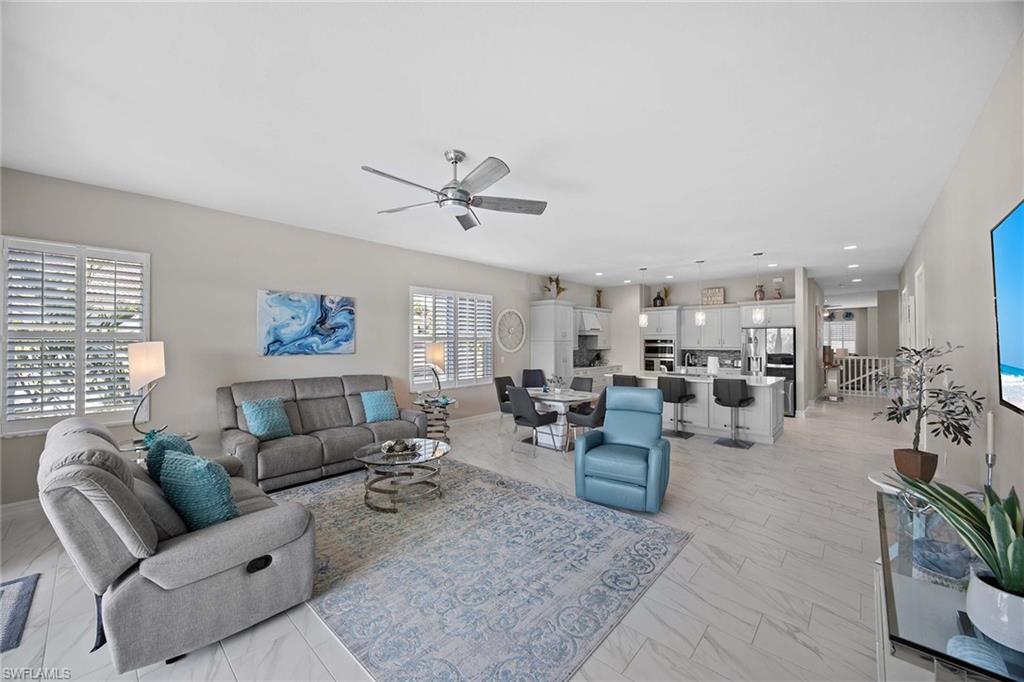 7781 Hawthorne Drive, Unit 3204 Naples, FL 34113 - Photo 12 of 50 a living room with furniture and a large window