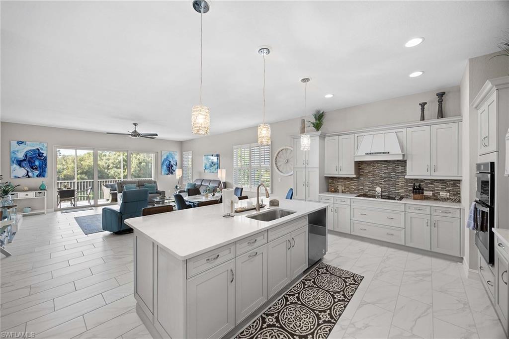 7781 Hawthorne Drive, Unit 3204 Naples, FL 34113 - Photo 16 of 50 a kitchen with a sink stove and cabinets