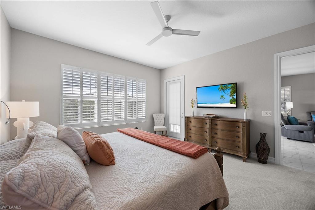 7781 Hawthorne Drive, Unit 3204 Naples, FL 34113 - Photo 23 of 50 a bedroom with a bed and a flat screen tv