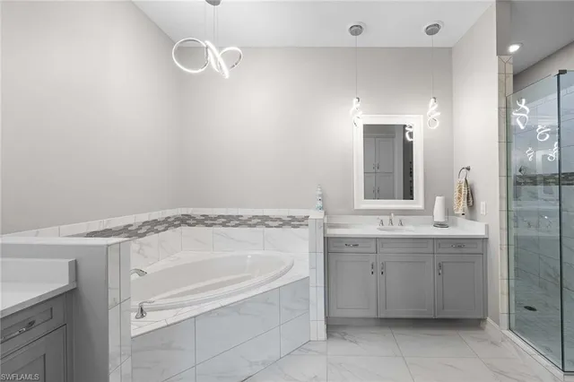 a bathroom with a tub sink and mirror