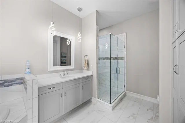 a bathroom with a shower sink and mirror