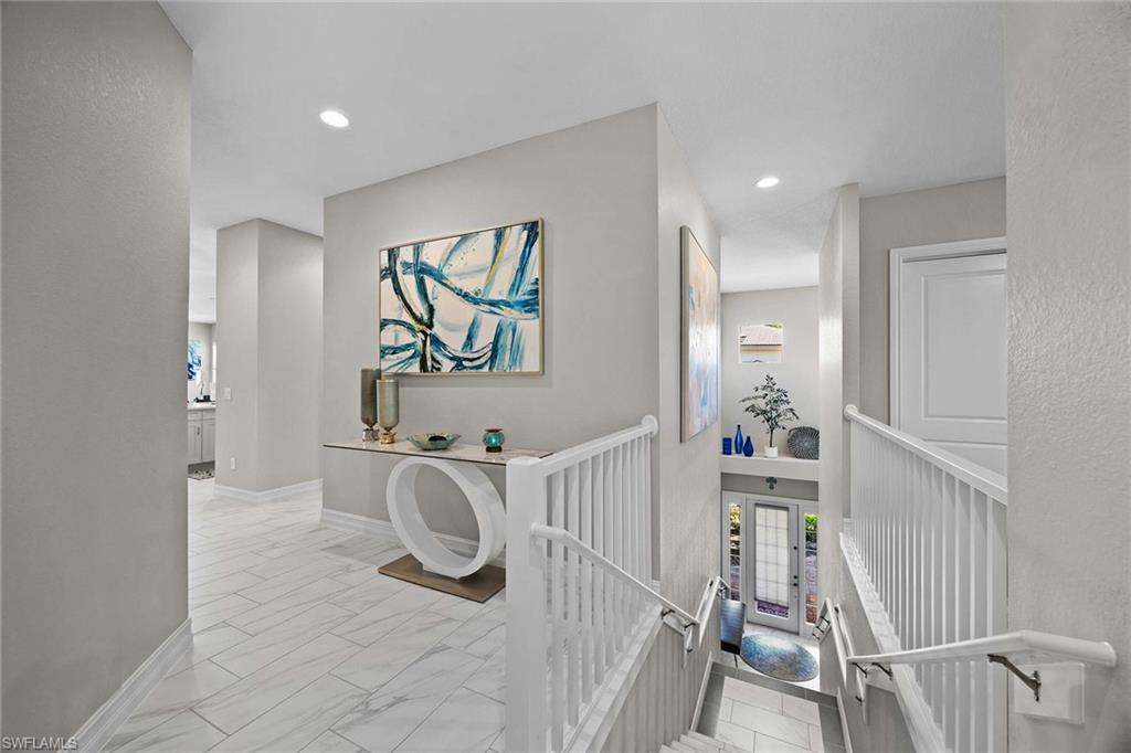 7781 Hawthorne Drive, Unit 3204 Naples, FL 34113 - Photo 32 of 50 a bedroom with furniture and a wooden floor