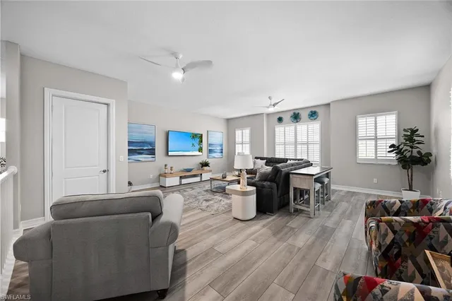a living room with furniture a dining table and wooden floor