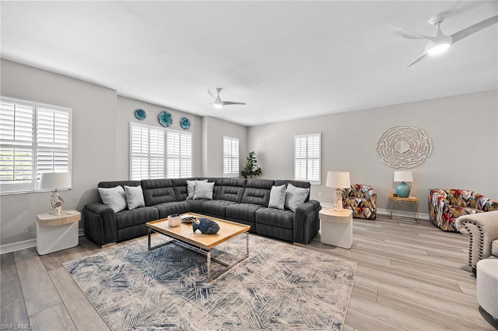7781 Hawthorne Drive, Unit 3204 Naples, FL 34113 - Photo 34 of 50 a living room with furniture and wooden floor