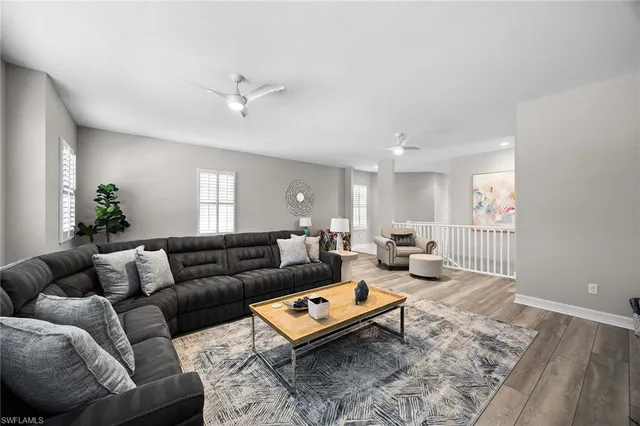 a living room with furniture a rug and a window