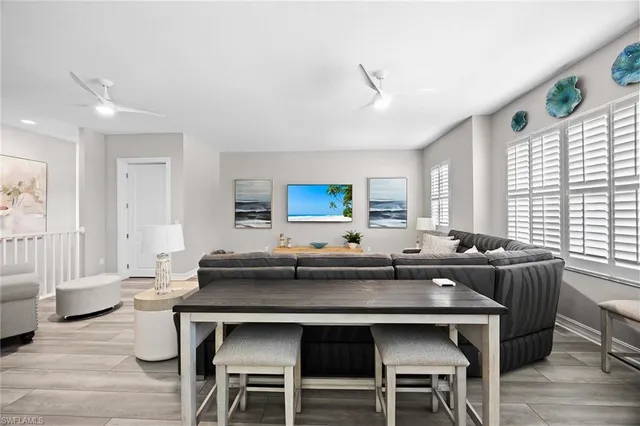 a kitchen with a table chairs and wooden floor