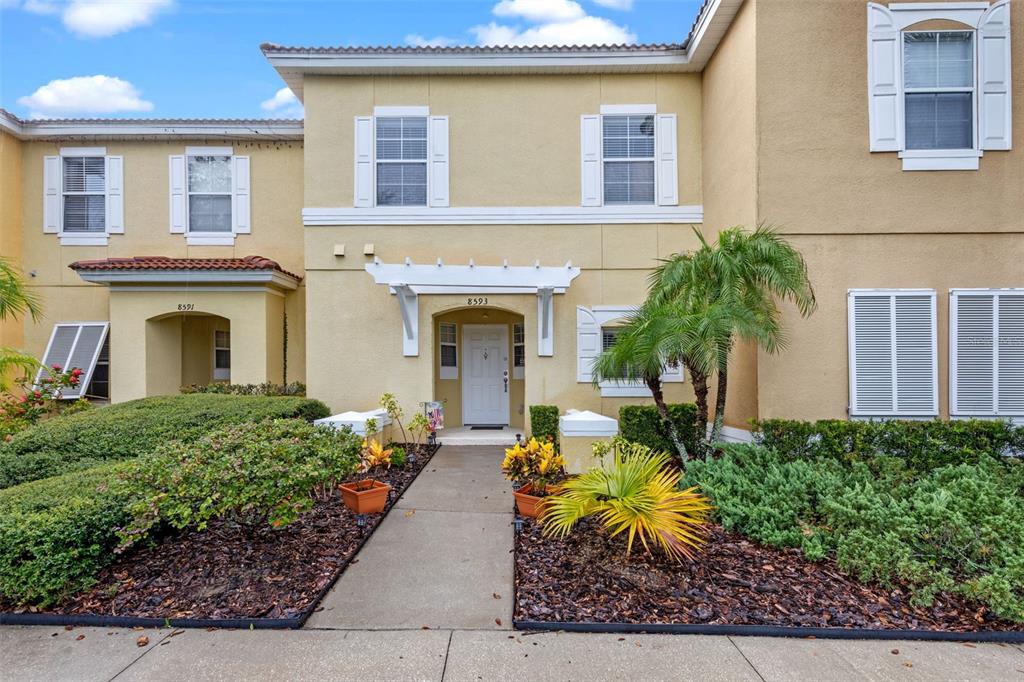 8593 Bay Lilly Loop Kissimmee, FL 34747 - Photo 1 of 1 a front view of a house with garden