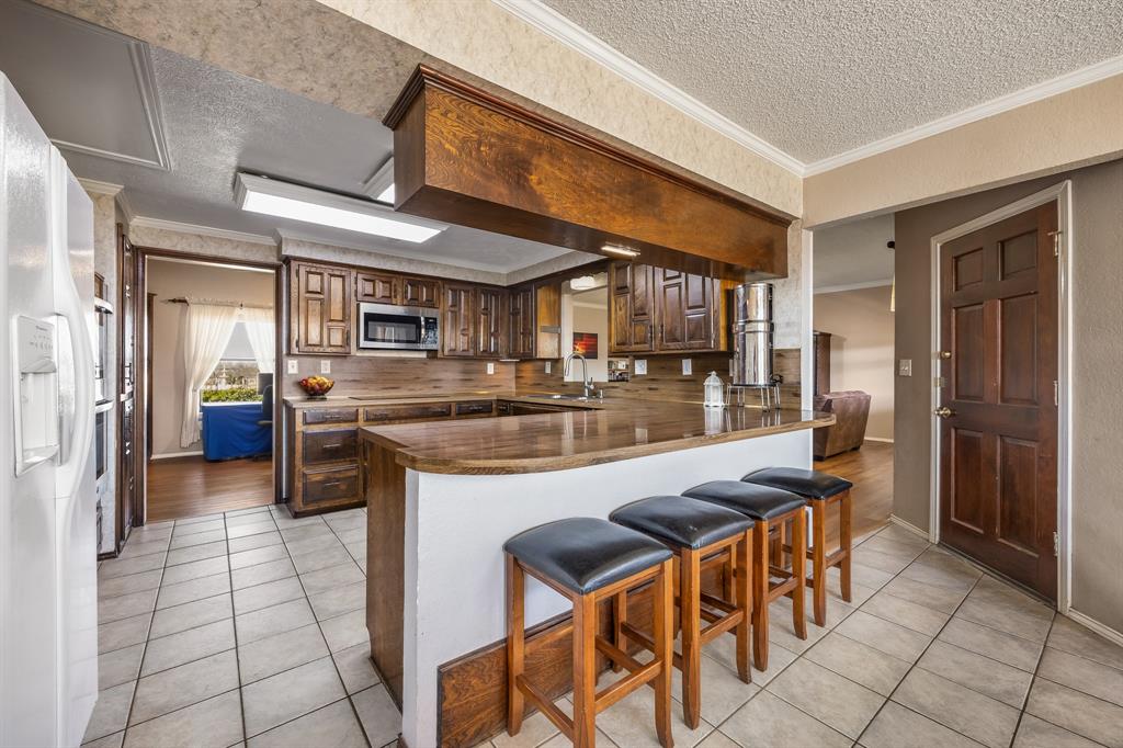 1439 Davis Lane Terrell, TX 75160 - Photo 11 of 33 a kitchen with stainless steel appliances granite countertop a sink and cabinets
