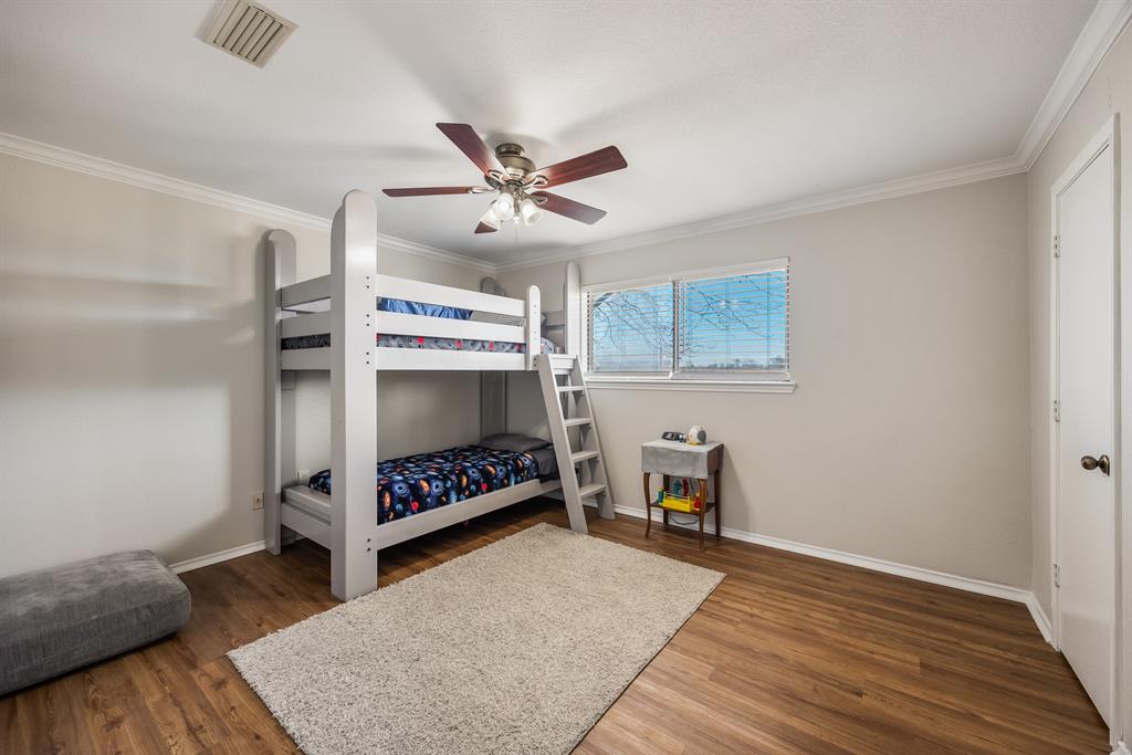1439 Davis Lane Terrell, TX 75160 - Photo 21 of 33 a view of an empty room with wooden floor and a ceiling fan