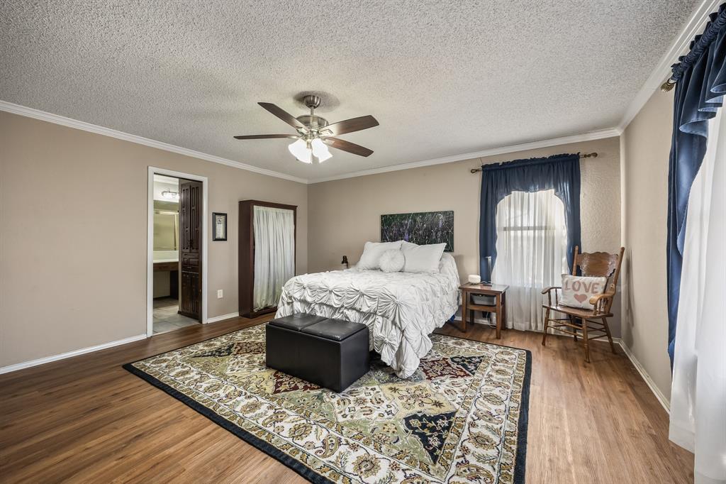 1439 Davis Lane Terrell, TX 75160 - Photo 24 of 33 a bedroom with a bed and a chandelier
