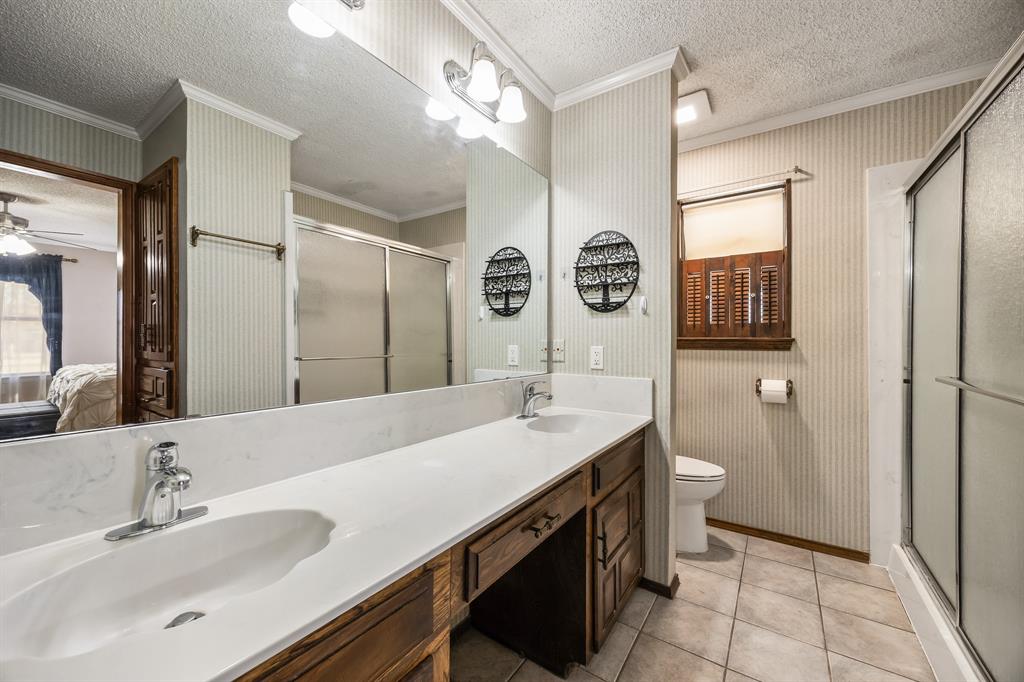 1439 Davis Lane Terrell, TX 75160 - Photo 25 of 33 a bathroom with a sink a toilet and shower