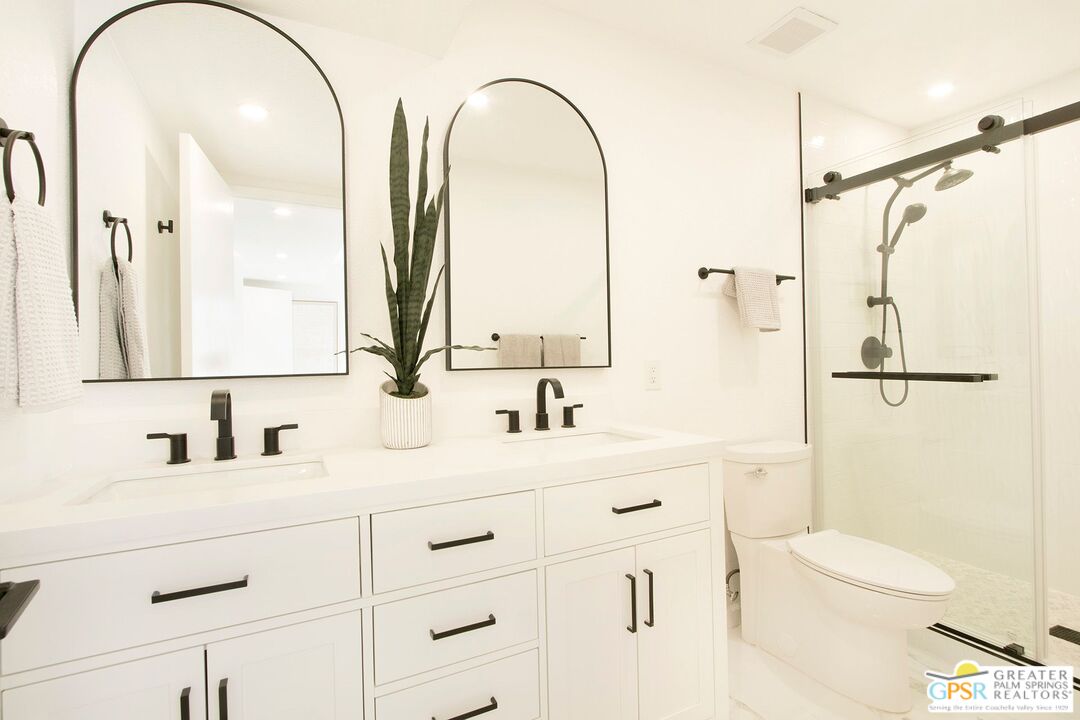 1100 East Amado Road, Unit 13C1 Palm Springs, CA 92262 - Photo 15 of 36 a bathroom with a double vanity sink mirror and toilet